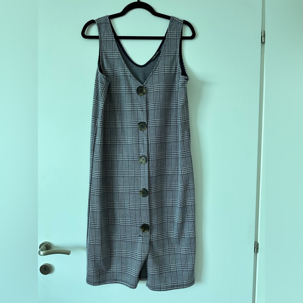 Plaid sleeveless dress with faux buttons.